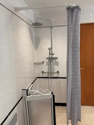a shower in a bathroom with a shower curtain at Wild Pheasant Hotel & Spa in Llangollen