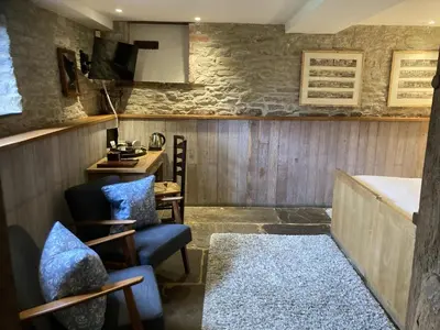 a living room with two chairs and a table at Old Downton Lodge in Downton
