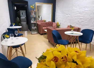 a restaurant with tables and chairs and yellow flowers at Peterstone Court Country House Restaurant & Spa in Brecon