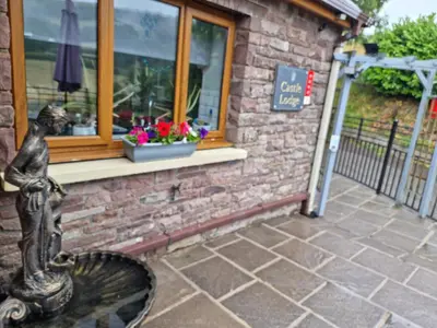 a statue in front of a building with a window at Castle Lodge - Brecon Beacons Accommodation in Sennybridge