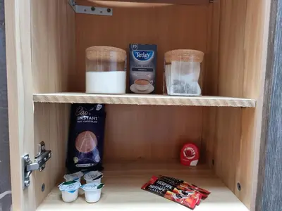 a wooden cabinet with some food items on it at Castle Lodge - Brecon Beacons Accommodation in Sennybridge