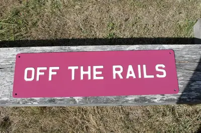 a pink sign that says off the rails at Off the Rails in Oswestry