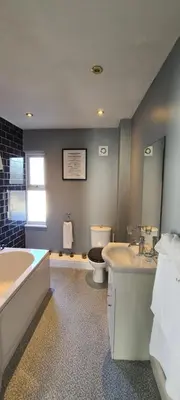 a bathroom with a tub and a sink and a toilet at Ty Morgan's in Rhayader