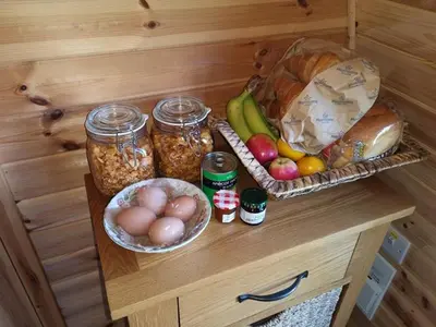 a wooden counter with some food and jars of food at Bwlcheinion Sea View Glamping in Machynlleth