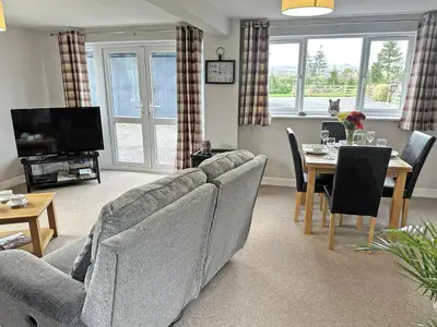 a living room with a couch and a table at Acorn Cottage in Kingsland