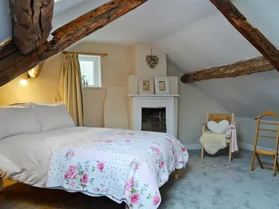 a bedroom with a bed and a fireplace at The Cider Barn in Presteigne