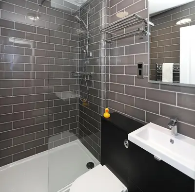 a bathroom with a toilet and a sink and a shower at The Castle Of Brecon Hotel, Brecon, Powys - The Coaching Inn Group in Brecon