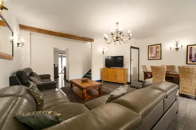 a living room with a couch and a table at The Barn in Aberystwyth