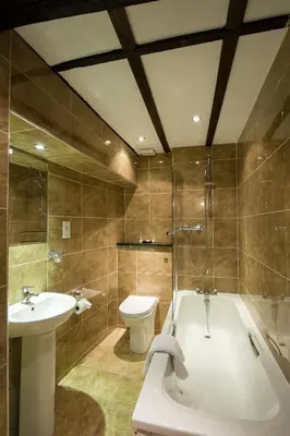 a bathroom with a tub and a toilet and a sink at Prince Rupert Hotel in Shrewsbury