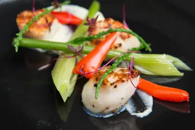 a plate of food with vegetables on a table at Prince Rupert Hotel in Shrewsbury