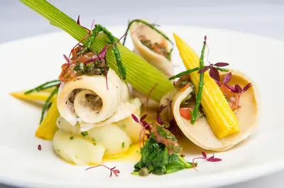 a plate of food with vegetables on a white plate at Prince Rupert Hotel in Shrewsbury