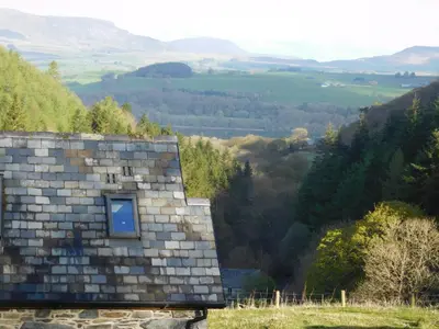 a small window on the roof of a house with a view at Glyn Mawr Barn in Bala