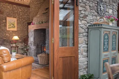 a door in a room with a stone wall at Cae'r Beili in Llandovery