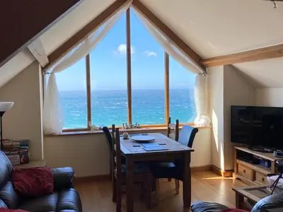 a dining room with a table with a view of the ocean at Beautiful Wales in Barmouth