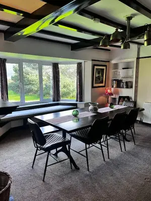 a dining room with a ping pong table and chairs at The Moorings in Fairbourne