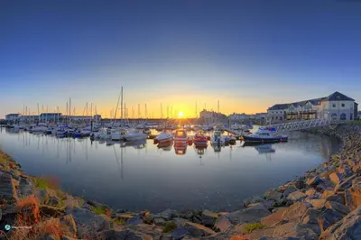a group of boats docked in a harbor at sunset at Queensbridge Hotel in Aberystwyth