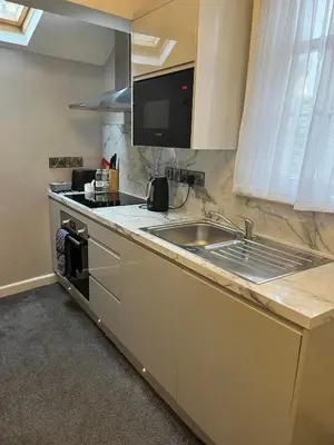 a kitchen with a sink and a counter top at Four Seasons Hotel in Aberystwyth
