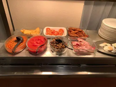 a refrigerator filled with different types of food in bowls at Four Seasons Hotel in Aberystwyth