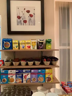 a shelf filled with food and other food items at Four Seasons Hotel in Aberystwyth