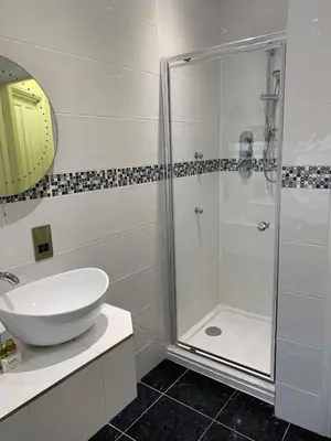 a bathroom with a shower and a sink at Four Seasons Hotel in Aberystwyth