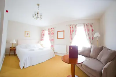 a living room with a bed and a couch at Four Seasons Hotel in Aberystwyth