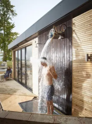 a young boy is playing in a water fountain at Fishmore Hall Hotel and Boutique Spa in Ludlow