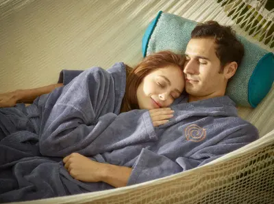 a man and a woman sleeping in a hammock at Fishmore Hall Hotel and Boutique Spa in Ludlow