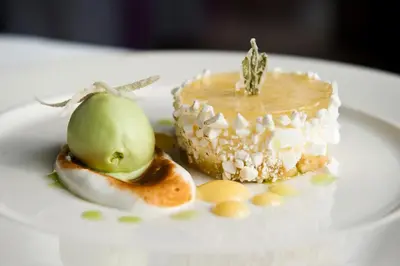 a piece of cake and an apple on a plate at Fishmore Hall Hotel and Boutique Spa in Ludlow