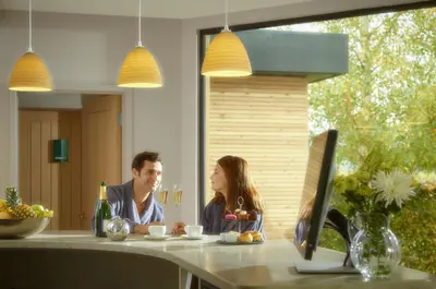 a man and woman sitting at a table with a computer at Fishmore Hall Hotel and Boutique Spa in Ludlow
