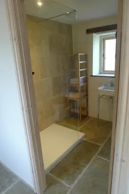 a shower with a glass door in a bathroom at Glanwye in Hay-on-Wye