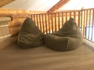 a pair of bean bags sitting on a balcony at Coed y Marchog Woodland Retreat in Hereford