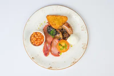 a plate of food with eggs bacon beans and toast at Lion & Pheasant Hotel in Shrewsbury