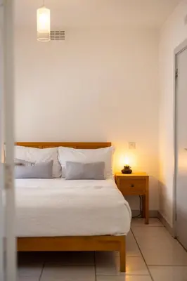 a bedroom with a bed and a night stand with a lamp at Lion & Pheasant Hotel in Shrewsbury