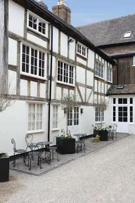 a building with tables and chairs in front of it at Lion & Pheasant Hotel in Shrewsbury