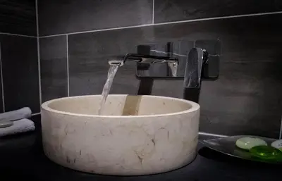 a stone sink with a water faucet in a bathroom at Devils Falls at the Luxury Hafod Hotel Aberystwyth in Devils Bridge
