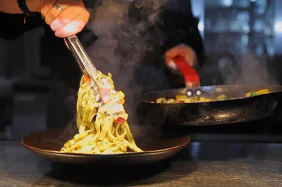 a person eating a bowl of noodles with chopsticks at Devils Falls at the Luxury Hafod Hotel Aberystwyth in Devils Bridge