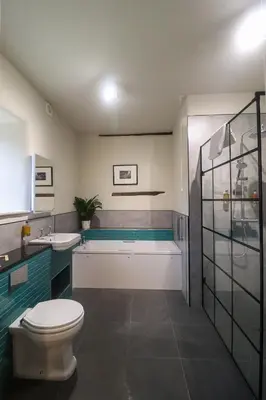 a bathroom with a toilet and a tub and a sink at The Castle Hotel in Bishops Castle
