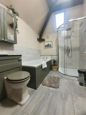 a bathroom with a shower and a toilet and a sink at The Castle Hotel in Bishops Castle