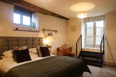 a bedroom with a large bed and a window at The Castle Hotel in Bishops Castle