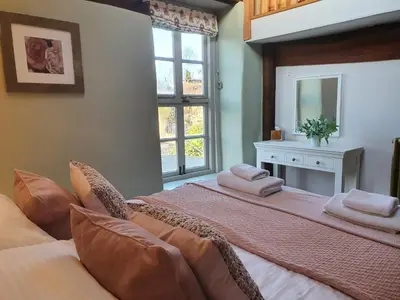 a bedroom with a large bed with towels on it at The Castle Hotel in Bishops Castle