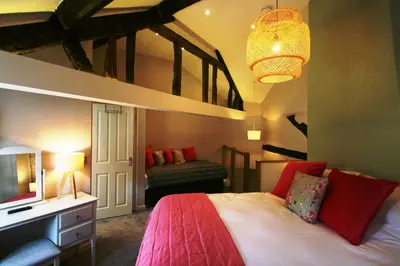 a bedroom with a king sized bed and a tv at The Castle Hotel in Bishops Castle