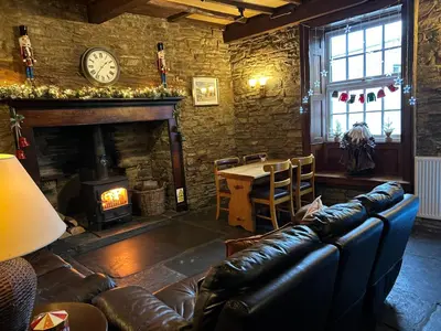 a living room with a couch and a fireplace at Castle Inn in Knighton