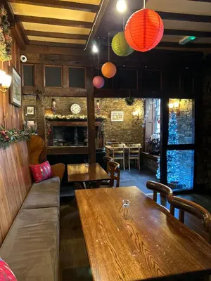 a dining room with a wooden table and chairs at Castle Inn in Knighton