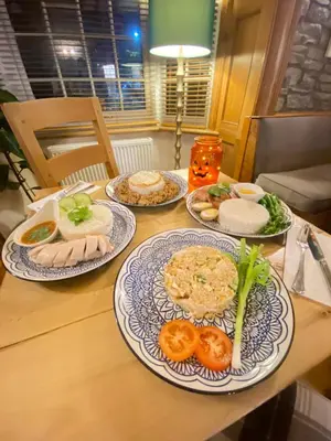 a wooden table with plates of food on it at Castle Inn in Knighton