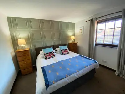 a bedroom with a large bed with two pillows on it at Castle Inn in Knighton