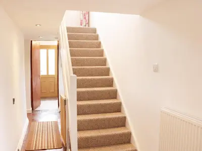 a stairway in a home with a stair case at Nant-Isa in Shelve