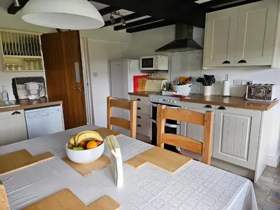 a kitchen with a table with a bowl of fruit on it at Nant-Isa in Shelve