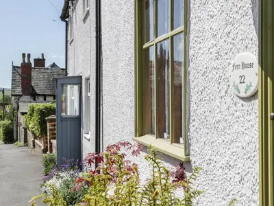a building with a window and a sign on it at Fern House in Craven Arms