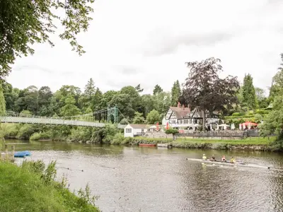 a group of people rowing a boat down a river at 7 Monkmoor Road in Shrewsbury