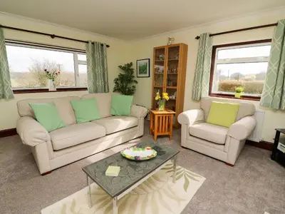 a living room with two couches and a coffee table at Blaenywawr in Cross Inn